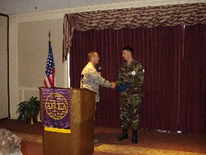Col. Appleyard presents a gift to Capt. David Canady, USAF, 3rd Combat Communications Support Squadron, for his presentation on radio over Internet protocol at the October chapter luncheon.